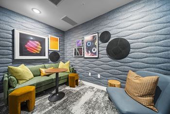 A living room with a blue couch and a green couch.